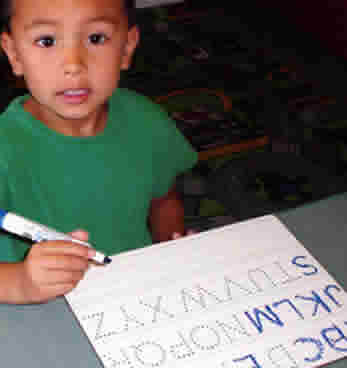 child at Woolly Mammoth Childcare & Pre-School learning to write